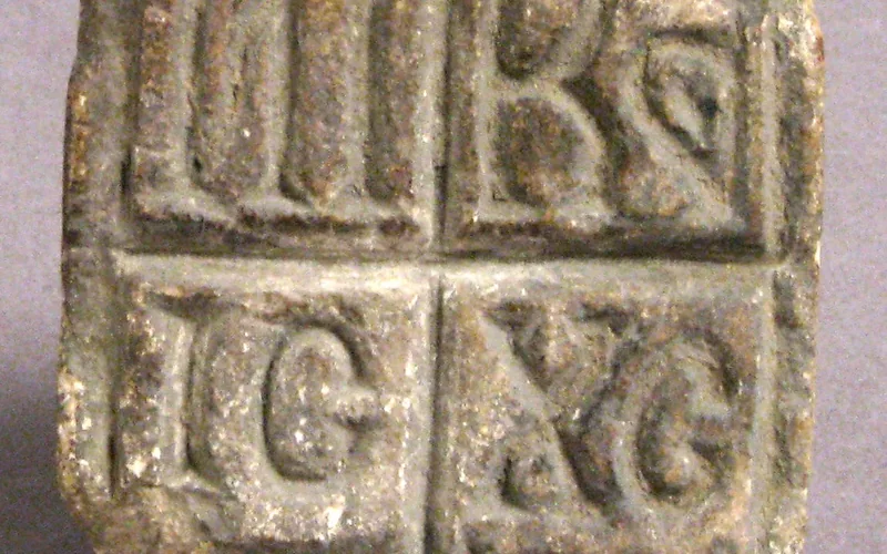 A Byzantine ceramic bread stamp photographed against a plain background.