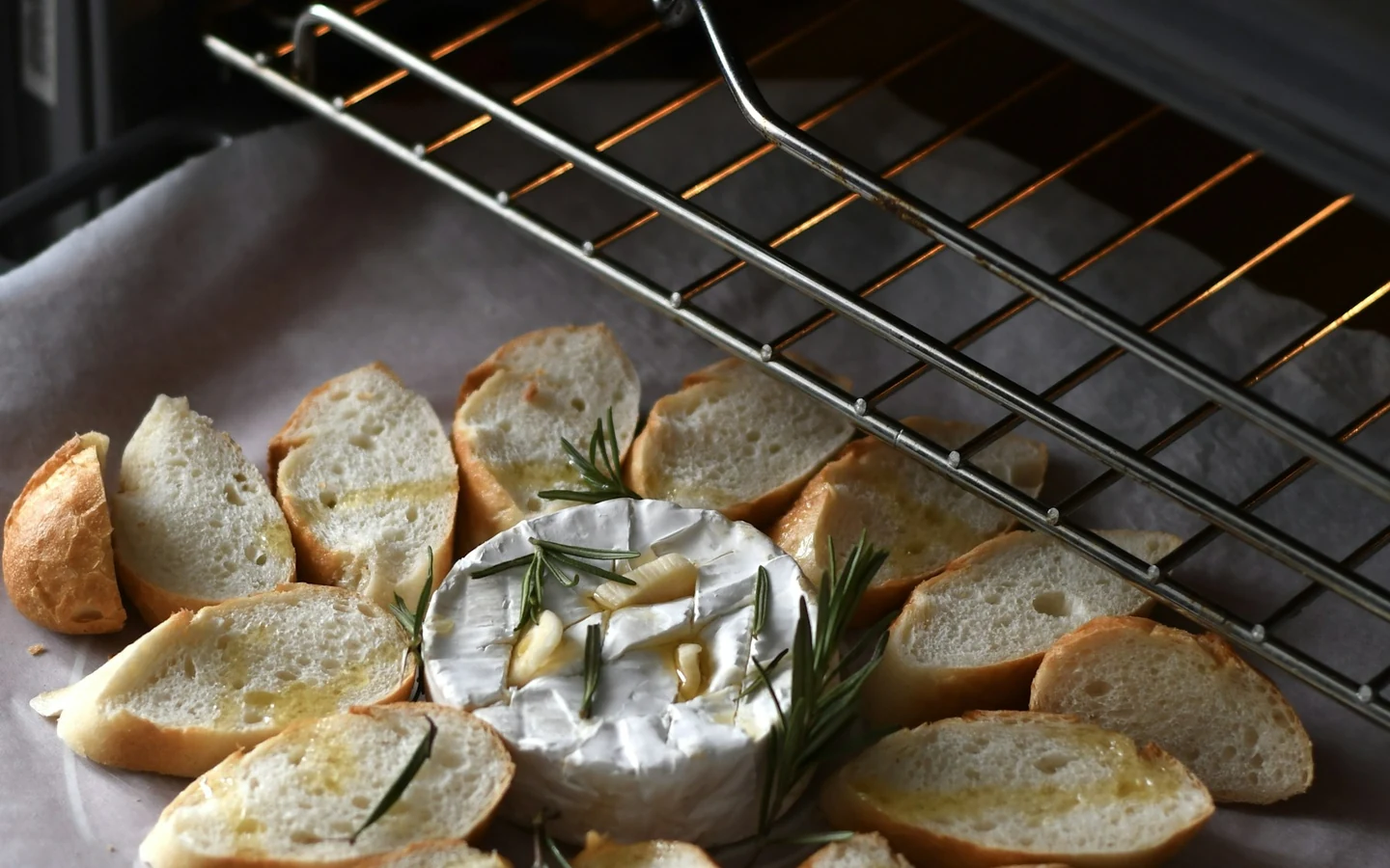 Baked bread sits on a metal oven tray.