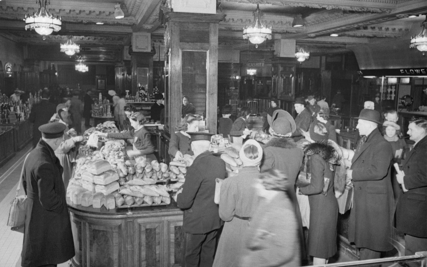 Shoppers queue at a London bakery counter in an archival photograph from 1942.